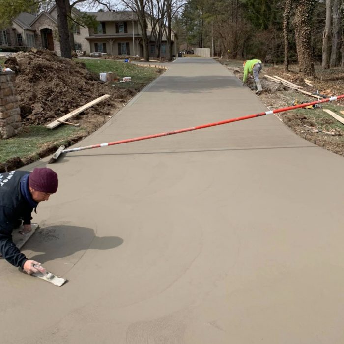 Concrete contractors finish driveway